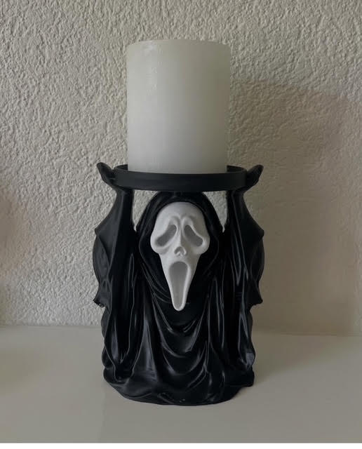 Zwart-witte decoratieve houder met een spookachtig gezicht